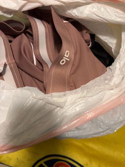 Bag with 7 Alo sets and 5 alo shirts and pants and 4 lululemon pants and 4 flawless luxe pants