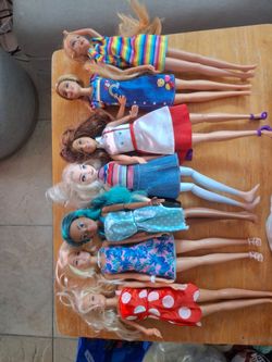 Lot of 8 Barbie Dolls with Outfits