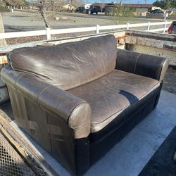 Small leather couch with fold out single bed