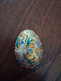 vintage cloisonné egg pendant with multicolor floral and scroll designs on a gold-toned metal base.