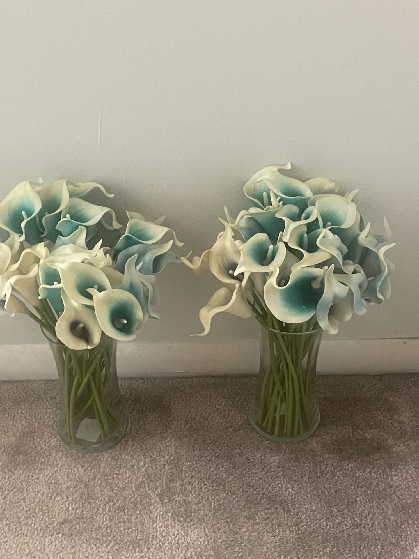 Calla Lilies in a clear glass vase.