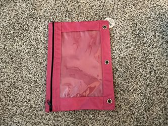 Pink zippered pencil pouch with clear window and metal grommets.