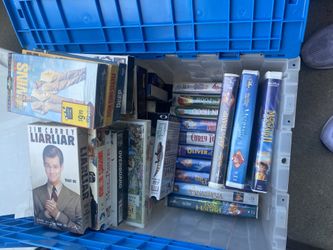 Two large tubs, full of VHS and DVDs quite a few Disney