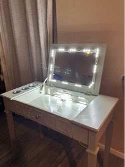 White vanity table with fold-up mirror and LED lights,