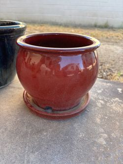 Glazed red ceramic pot with drain hole