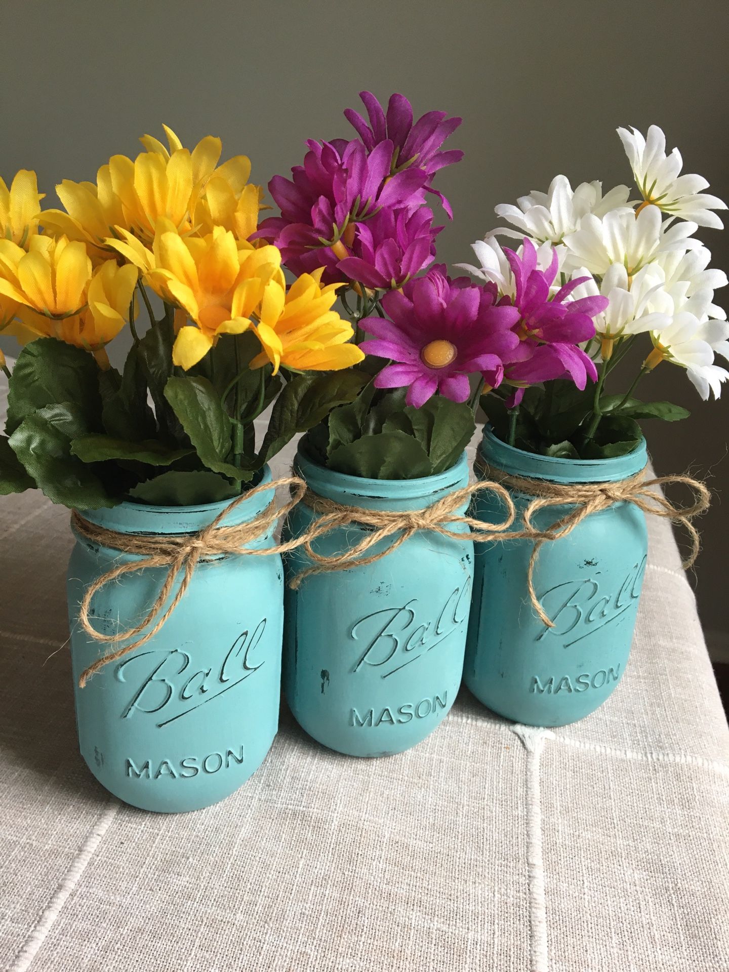 Distressed mason jar vases with silk flowers included! $13 for 3 you pick the jar/flower colors