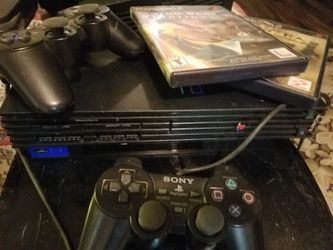 Playstation 2 with 2 controllers and 3 Games