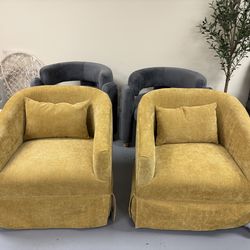 Brand new Stylish set of two accent armchairs. Each chair has 360-degree swivel. Upholstered in a vibrant mustard yellow textured fabric. Design is a 