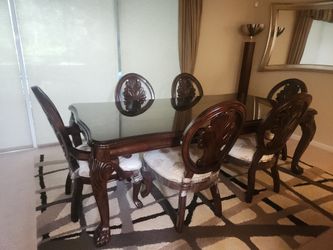 Solid mahogany dining set with six chairs and a beveled glass top