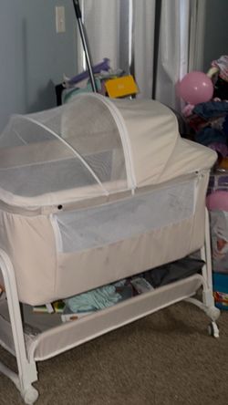 on the bottom Cream color Baby bassinet with storage on the bottom