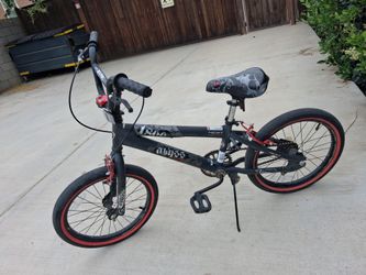 Charcoal gray Kent 18' Abyss boy's freestyle BMX bike.