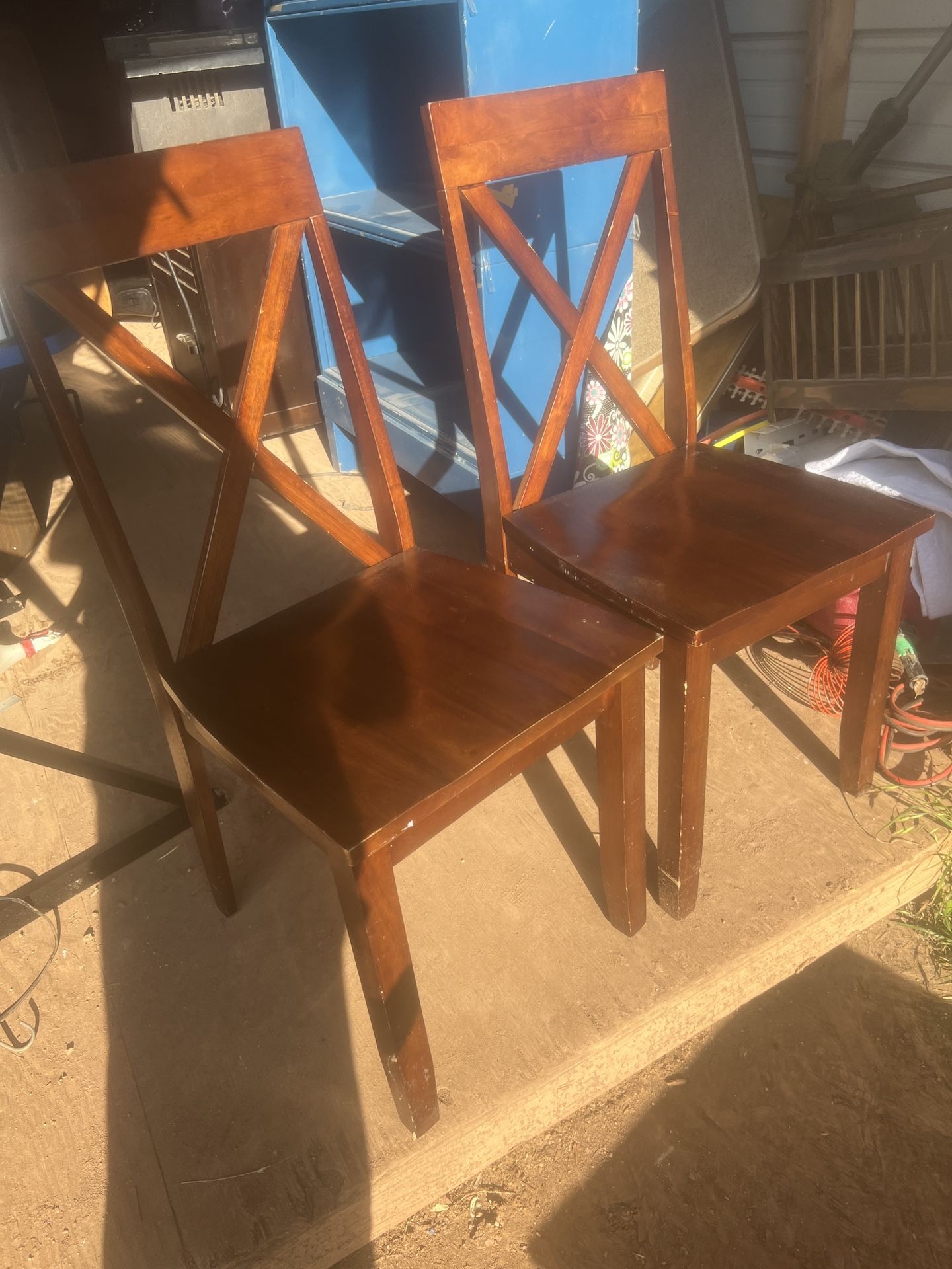 a pair of nice wood chairs seats are 18 inches tall