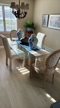 6 ft x 3 1/2 ft glass table with six upholstery chairs