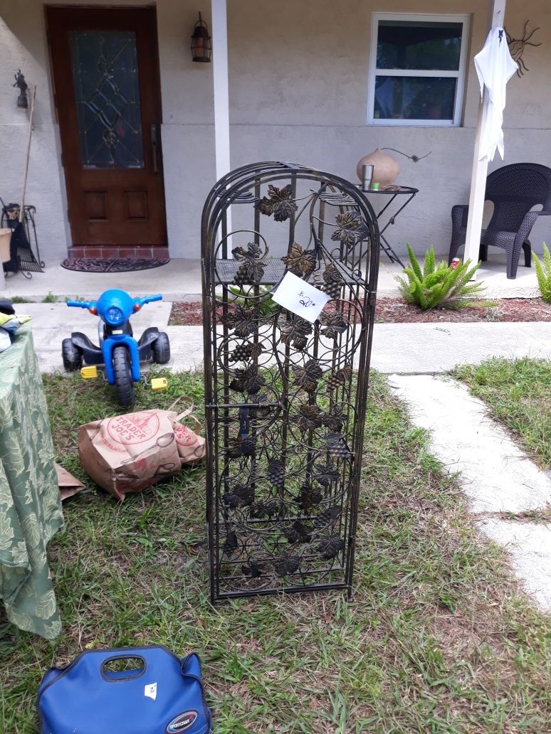 A beautiful metal wine rack with Vine detail approximately 4 ft tall