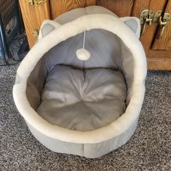 Cozy pet bed with hanging toy
