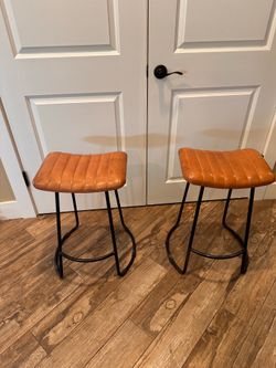 Two leather stools