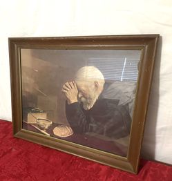 Vintage old man with bread in solid wood frame praying grace