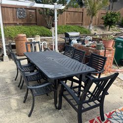 Metal patio table and 8 chairs
