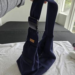 Pet Sling With Adjustable Strap And Zippered Pocket For Treats 