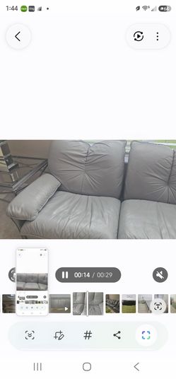 Gray Leather Sofa With a coffee table and a lamp table.
