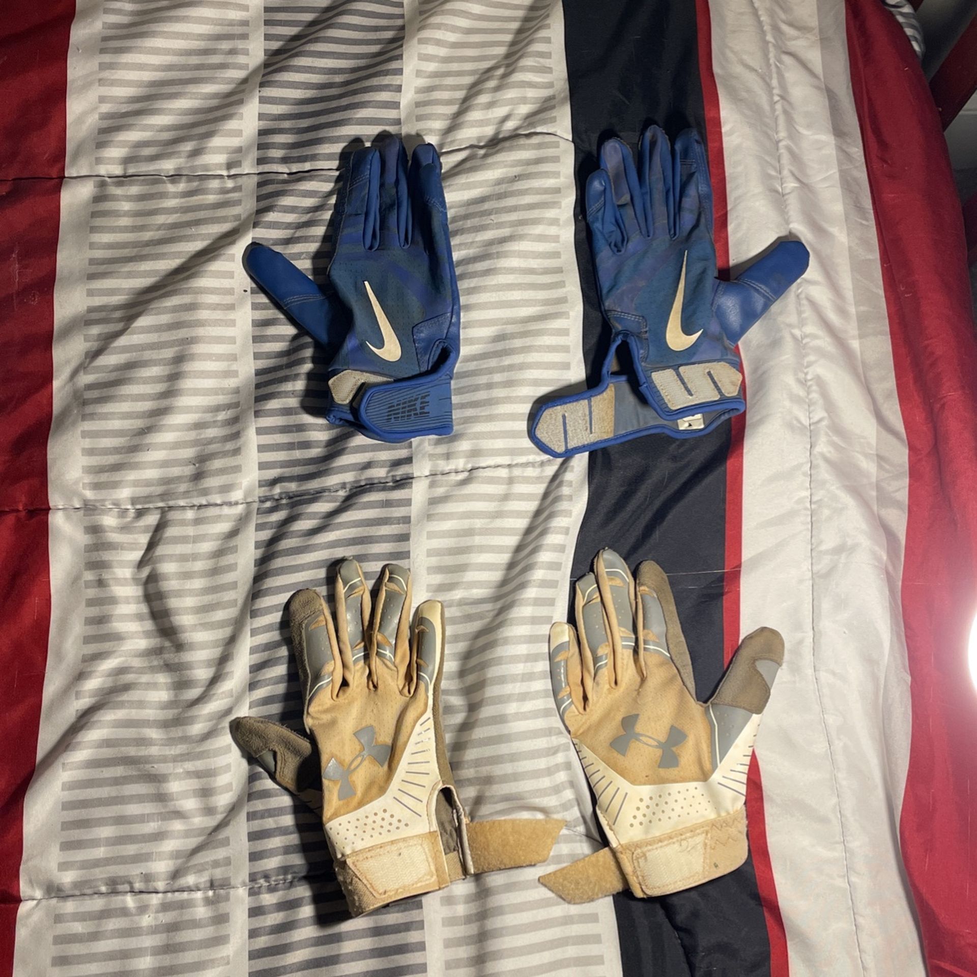 Blue Nike Baseball Gloves And Grey UnderArmor Baseball Gloves