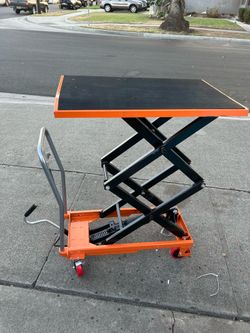 manual hydraulic double-scissor lift table cart, typically rated for a 770 lbs load