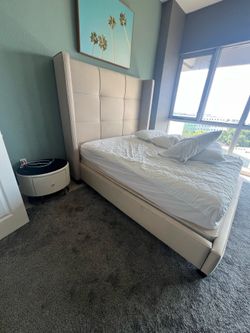 Queen size bed with mattress and end table