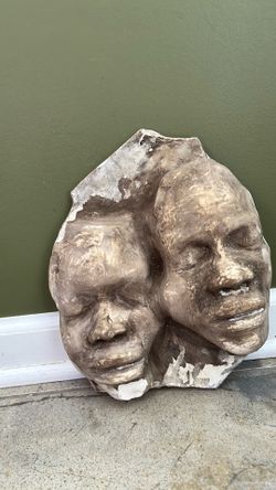 Stone cement mold of 2 men’s faces abstract