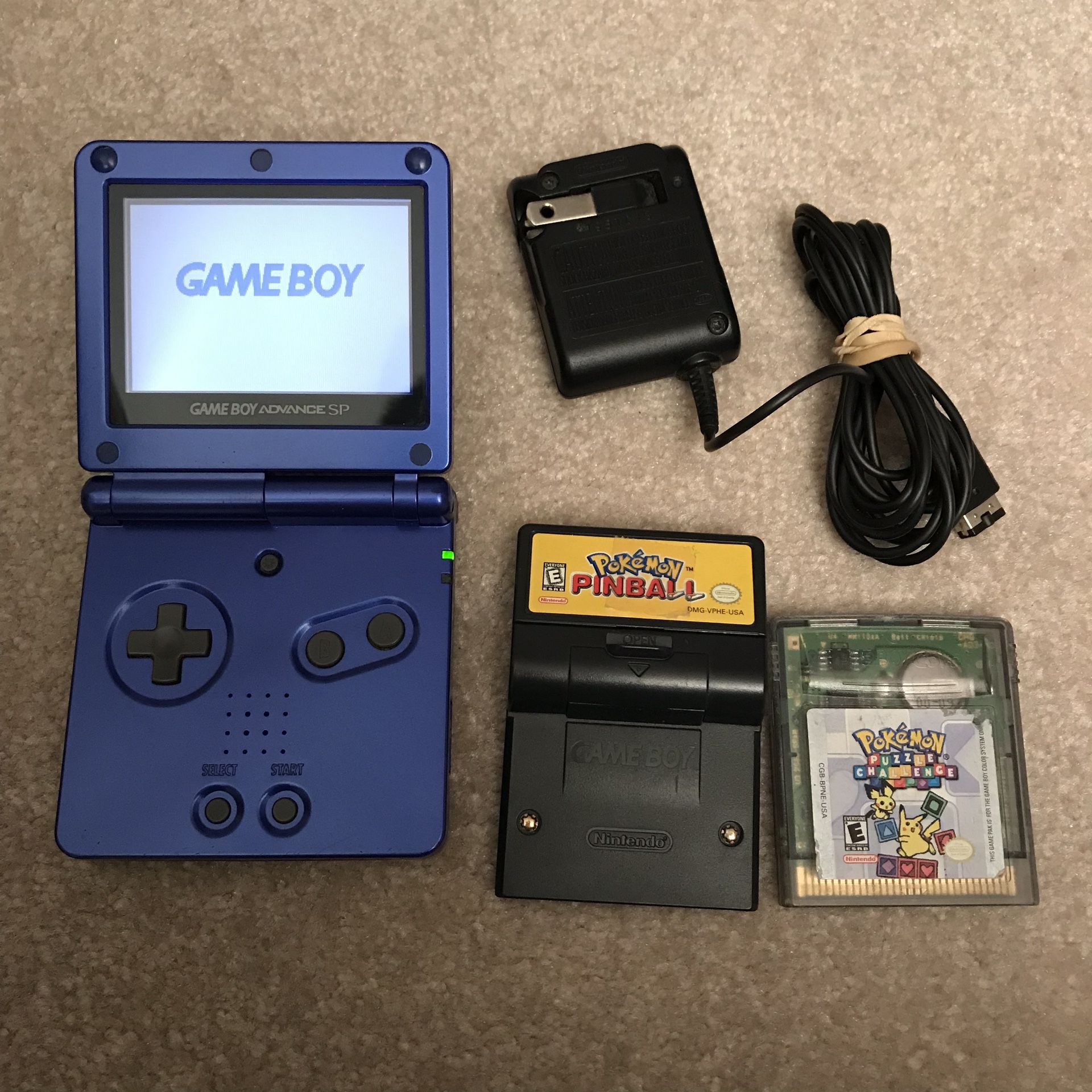 Blue gameboy advance sp with 2 games pokemon pinball puzzle challenge with charger