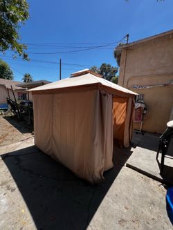 gazebo tent with chairs and table