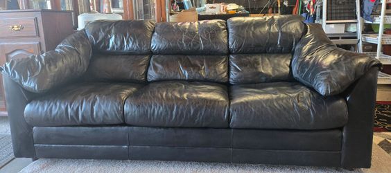 Leather couch , matching a leather love seat, matching leather slide chair with footstool.