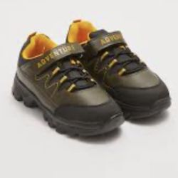 This is a pair of kids' black and yellow trekking shoes with a hook-and-loop strap labeled "ADVENTURE".