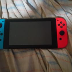 Nintendo Switch With Blue And Red Controller 
