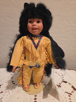 This porcelain doll is the "Little Bear Dancer" created by artist Elke Hutchens for the Danbury Mint in 1994.