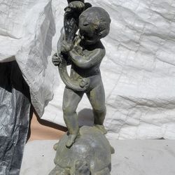 Very heavy lead statue of a boy standing on a turtle is a fountain
