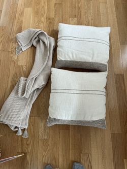Two cream throw pillows + throw blanket