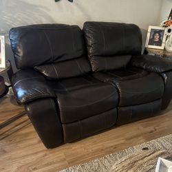Rocking and reclining sofa is made of leather