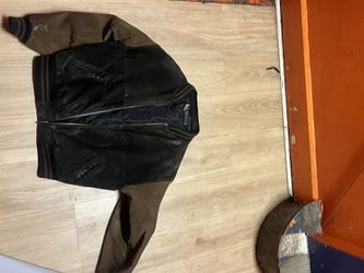 This is a vintage black and brown suede leather varsity jack
