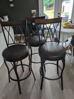 3 bronze rubbed swivel bar stools