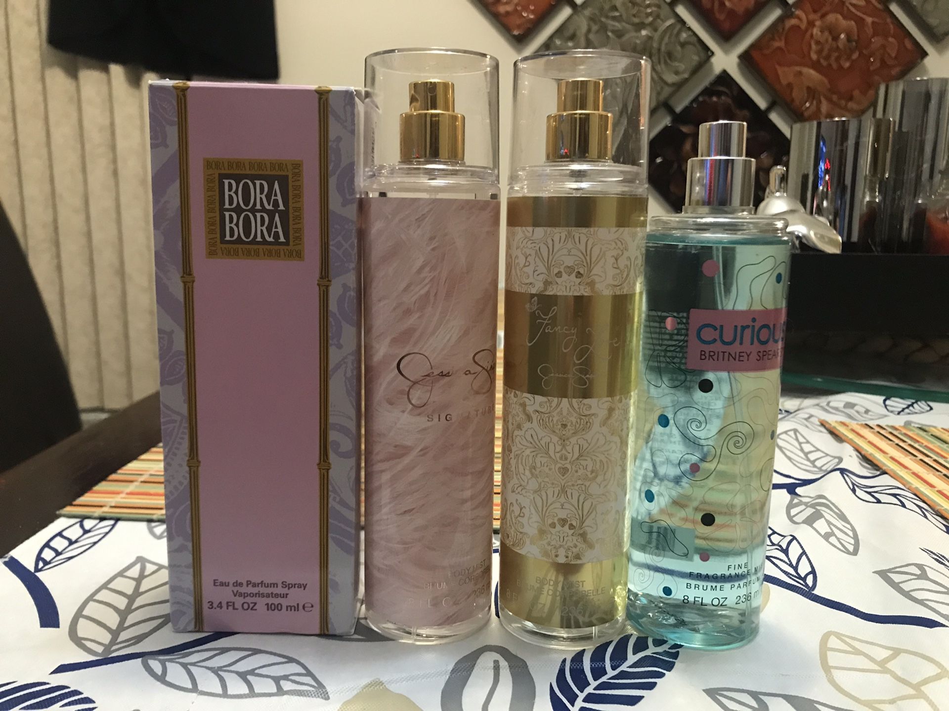 Assortment of body sprays and a perfume