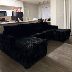 corduroy fur like sectional sofa with double chaise and two accent pillows. 