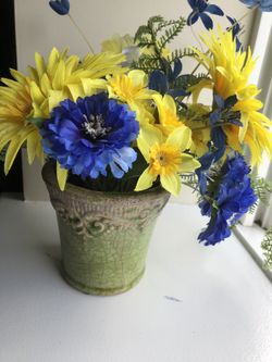 artificial flowers in a ceramic pot