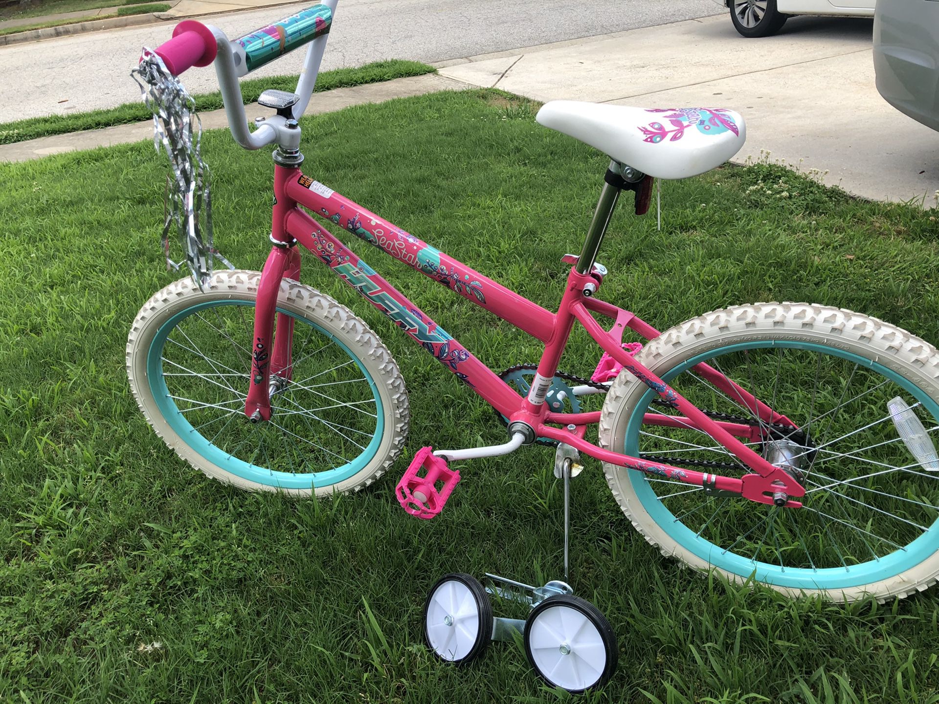 Pink bicycle with training wheels
