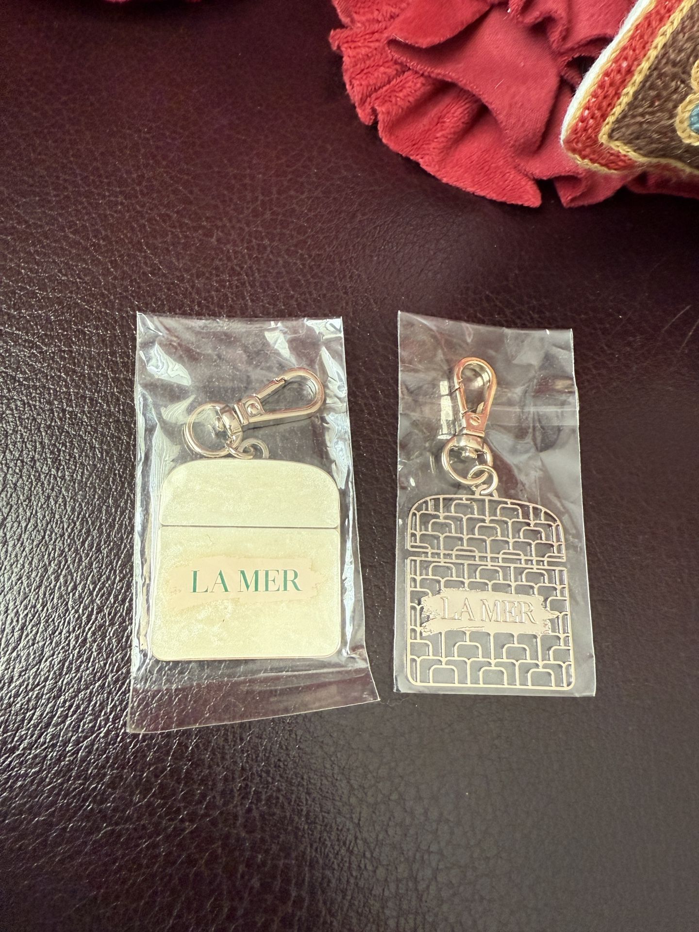 La Mer Gold and Silver Keychain Duo