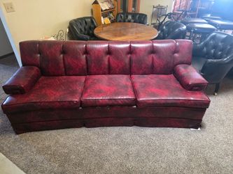 Red couch folds into queen size bed