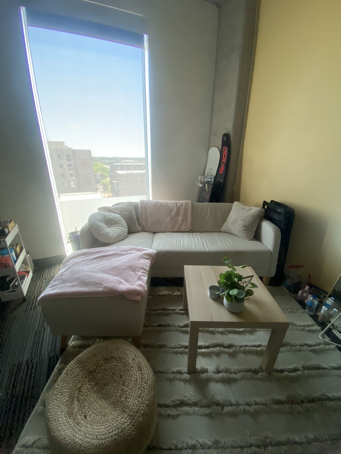 small beige sectional & coffee table