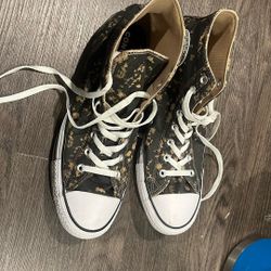 high-top Converse ( Chuck Taylor / Chuck 70 / All Star style with a black canvas Base And A bleach-splatter effect.