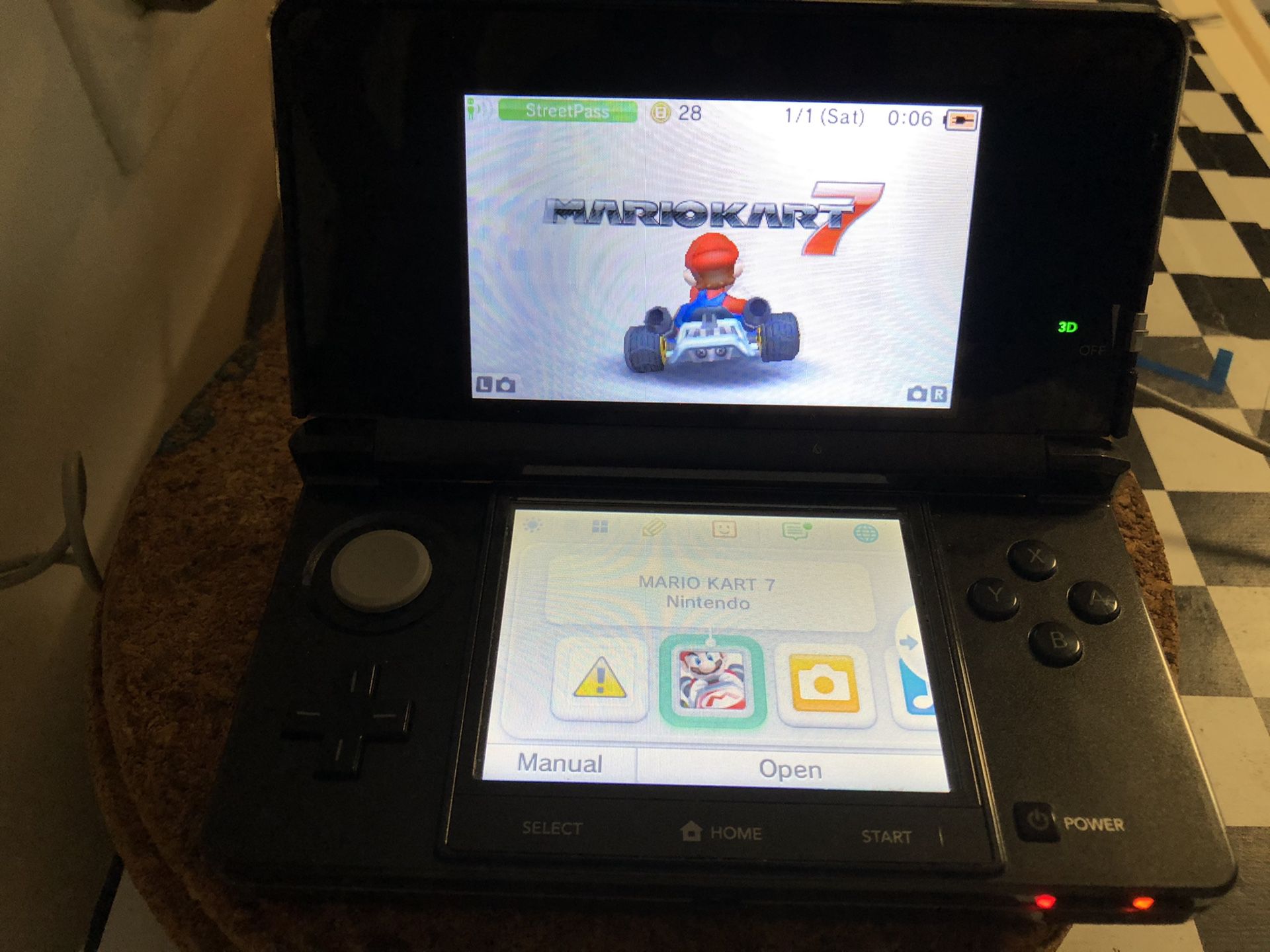 Nintendo 3DS with Mario kart game and charger