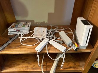 WII  console two remotes charger and games
