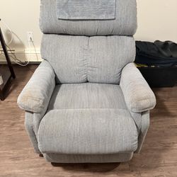 Set of 2 separate blue reclining armchairs.